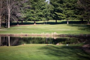 View of water separating the tee box from the green.