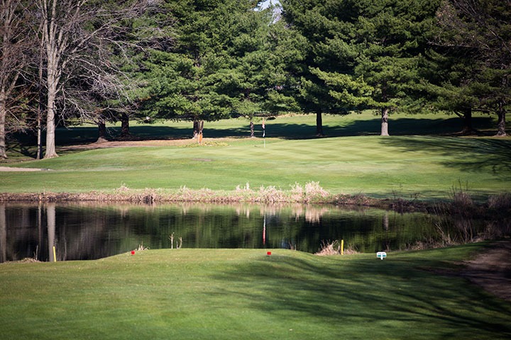 View of water separating the tee box from the green.